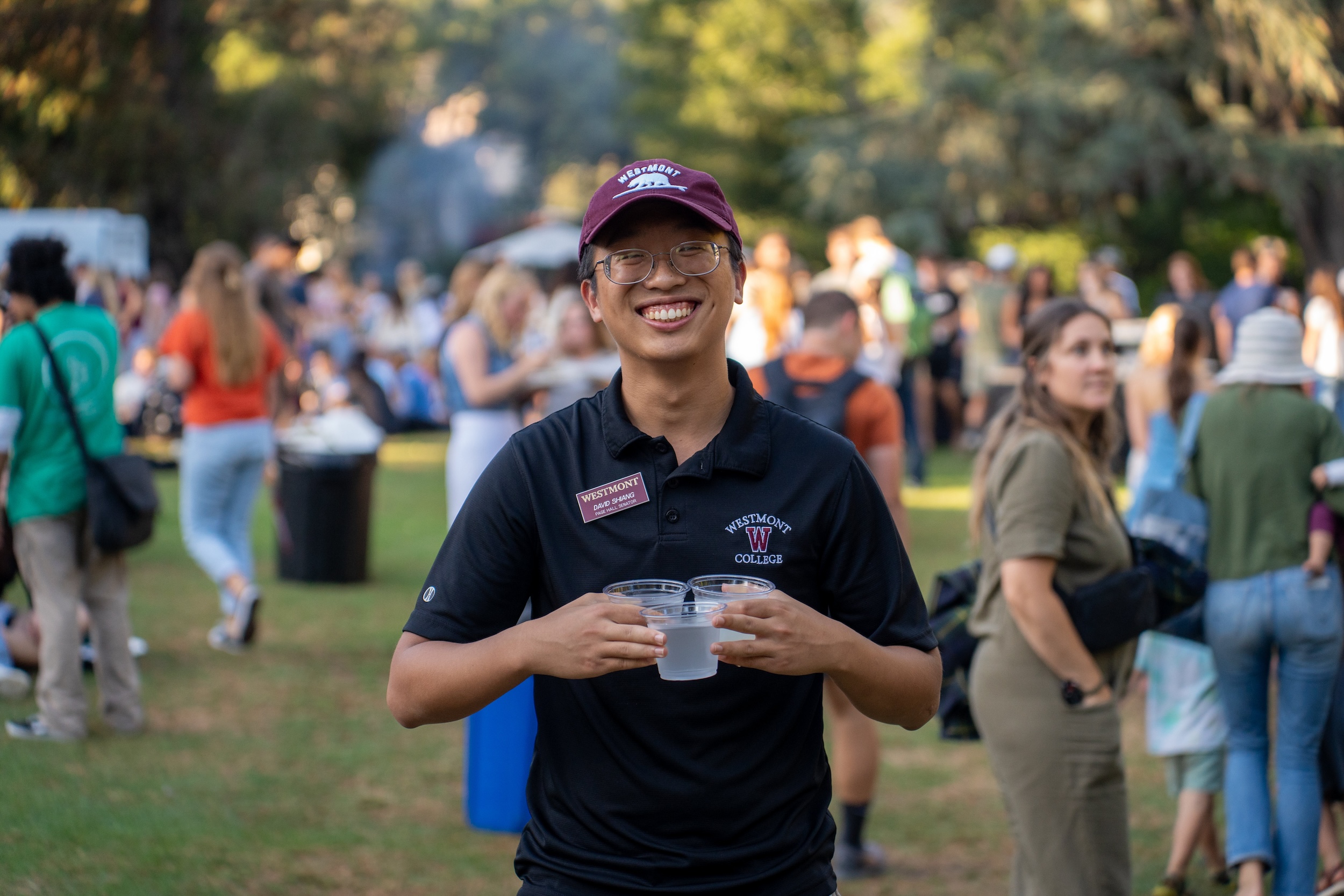 student carrying water at event