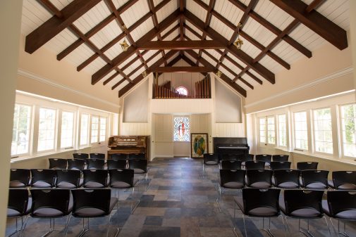 Warm light basks in the renovated prayer chapel. These temporary chairs will be replaced with wood-framed, fabric-covered chairs