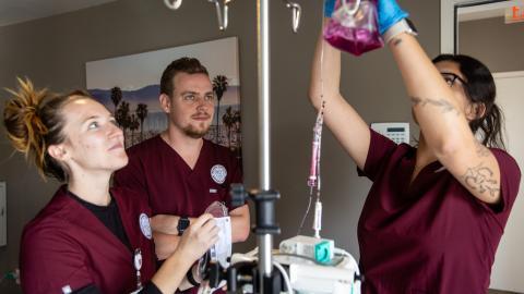 westmont nursing students hanging fluid bag