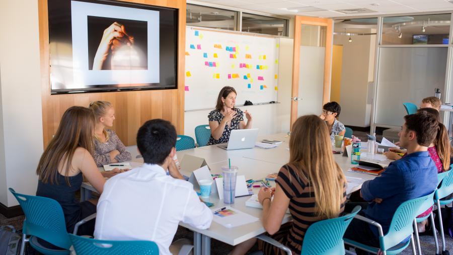 Students innovating around a table