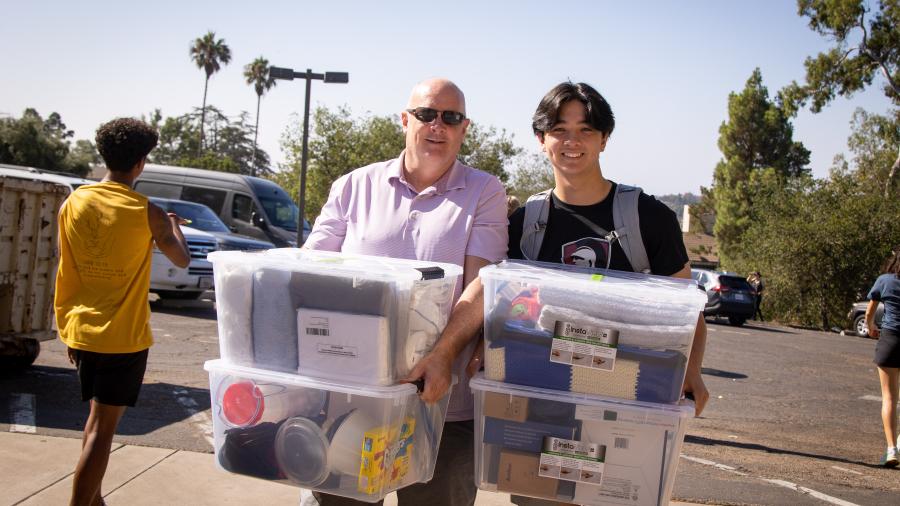 A father and son move items into a Westmont dorm.